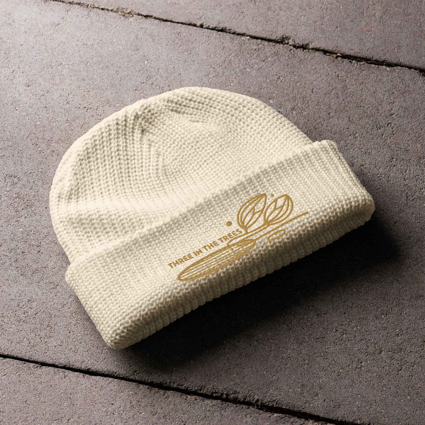 fisherman beanie, ecru, Three in the Trees laid out design embroidered