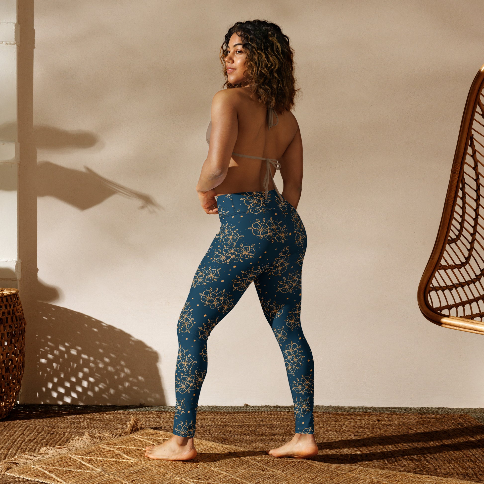 all over print yoga leggings, blue green with ochre blossom print, Clara design, model back