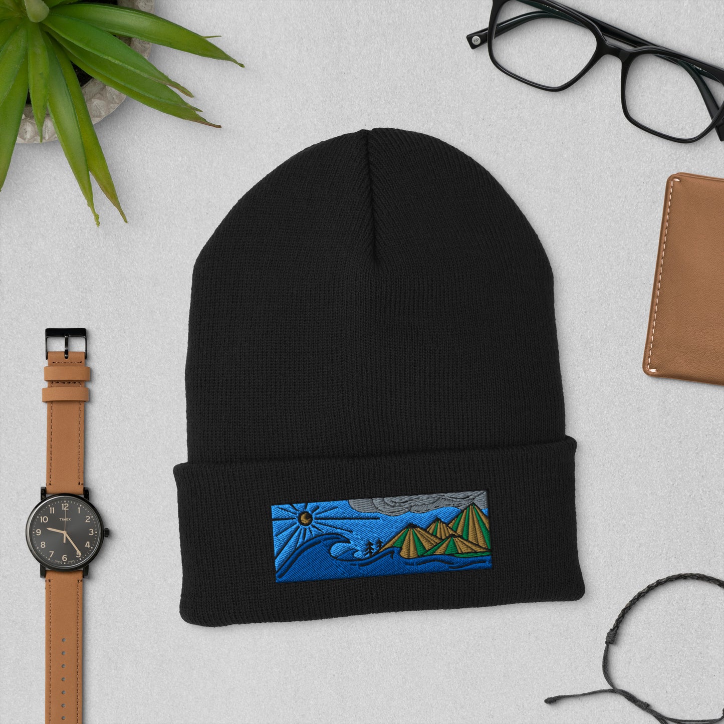 Product mockupcuffed beanie, colored embroidery of seascape and mountains, black